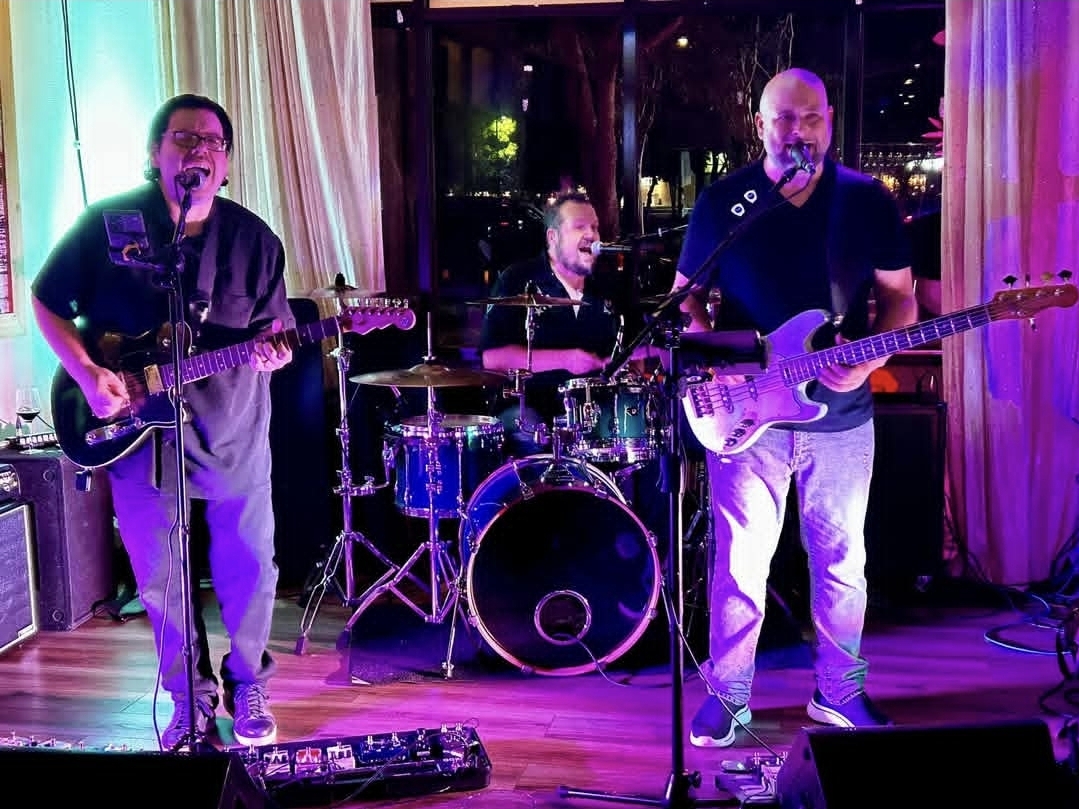 Jack Miele on Telecaster with a trio under purple and teal stage lights