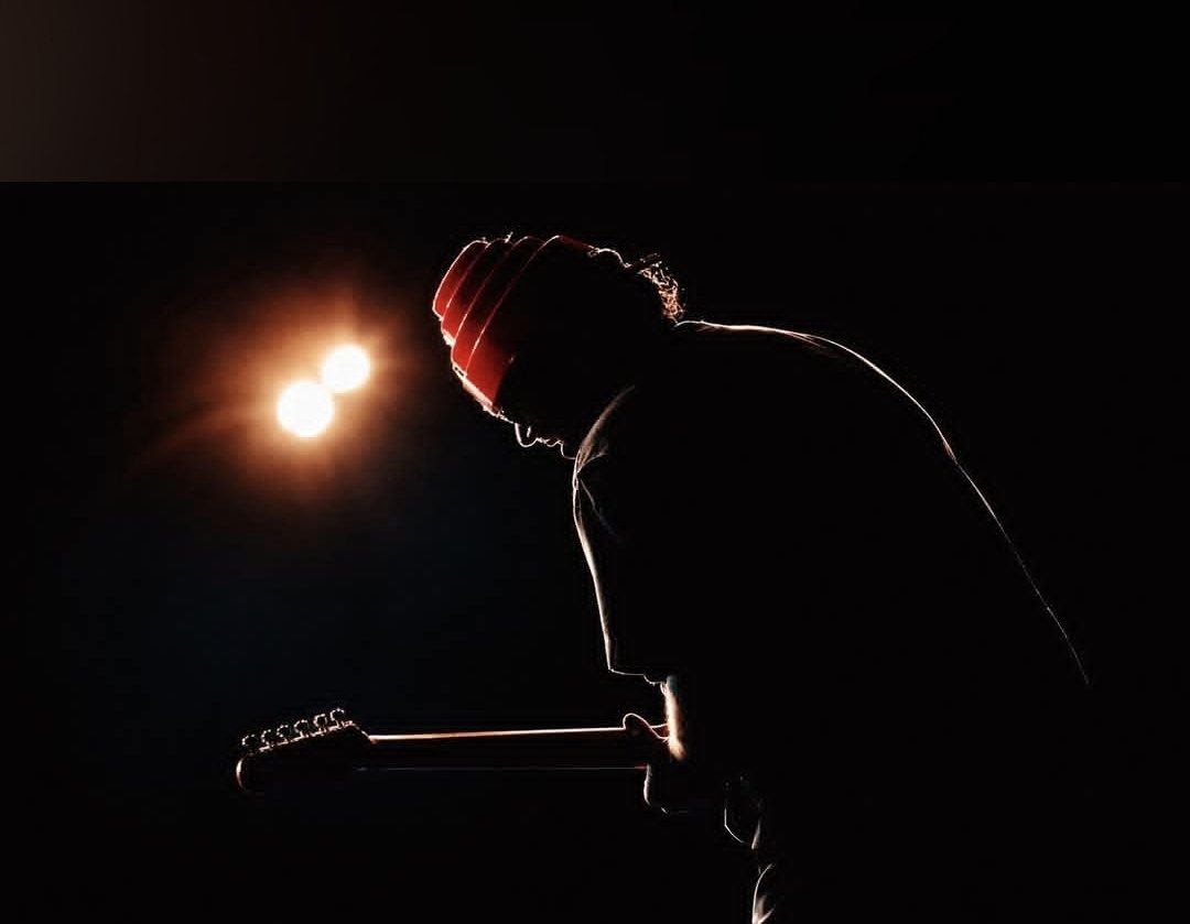 Jack Miele silhouetted on stage with The Molly Ringwalds